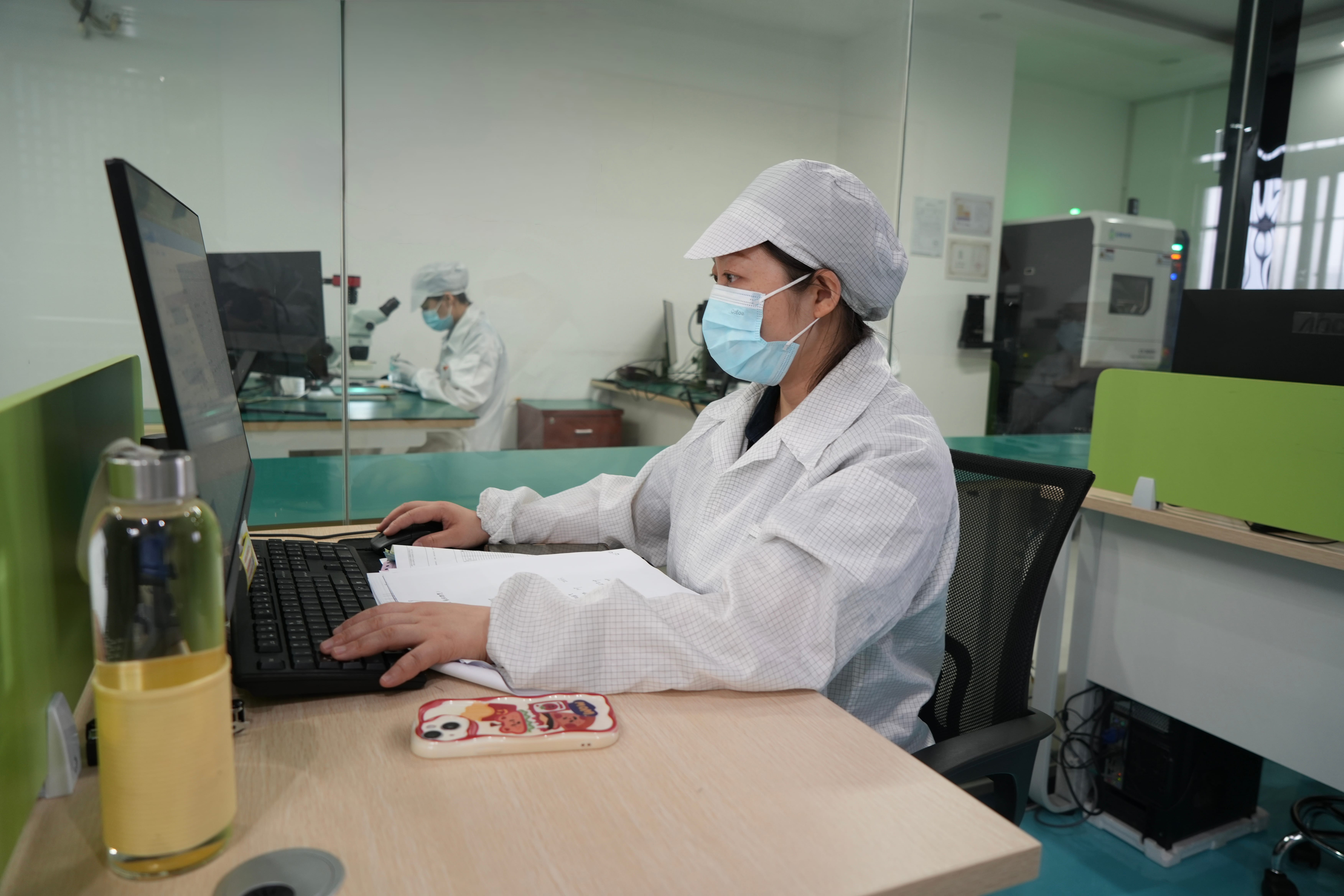 Quality inspector reviewing electronic component documentation and records