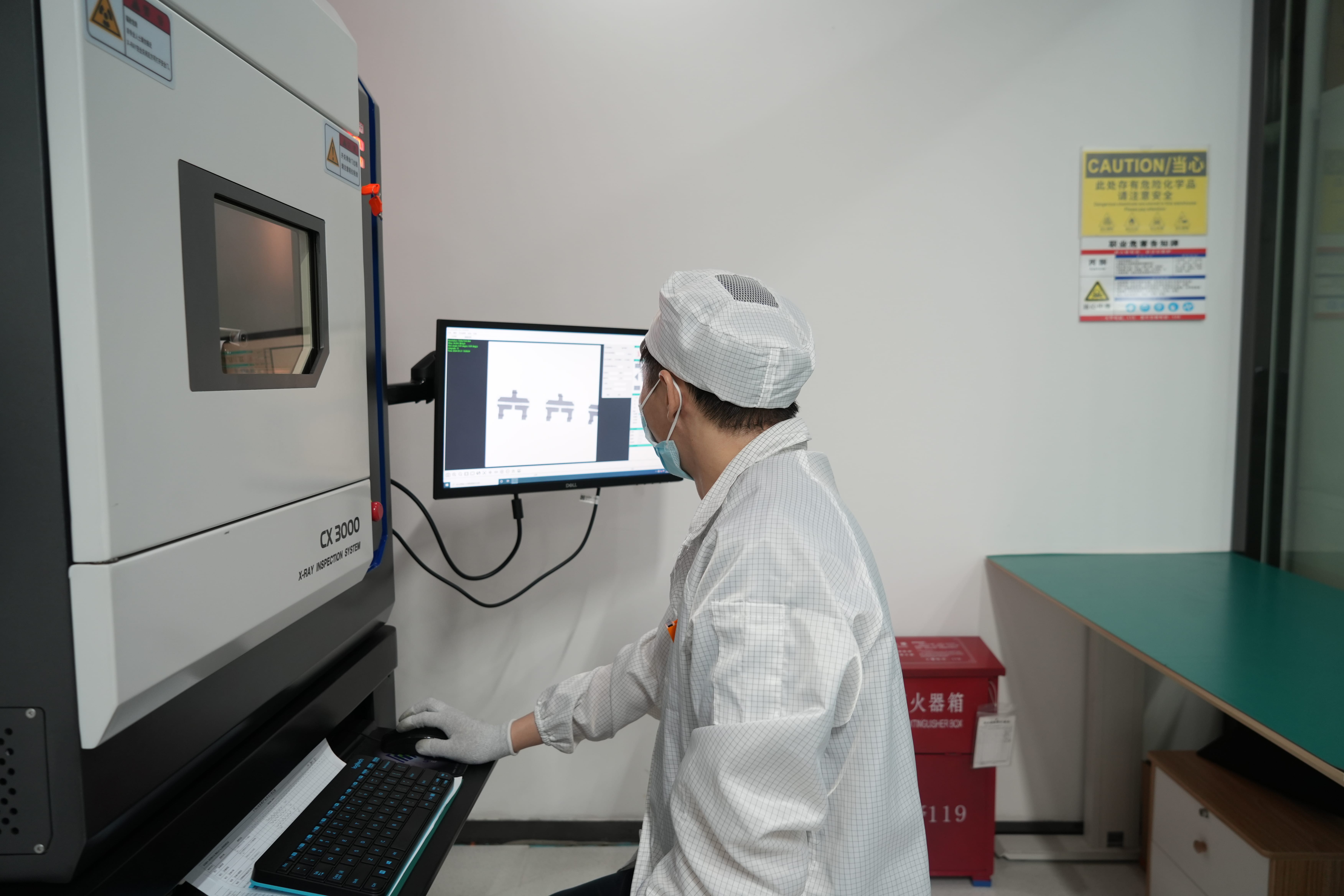 Laboratory technician operating an X-ray inspection system